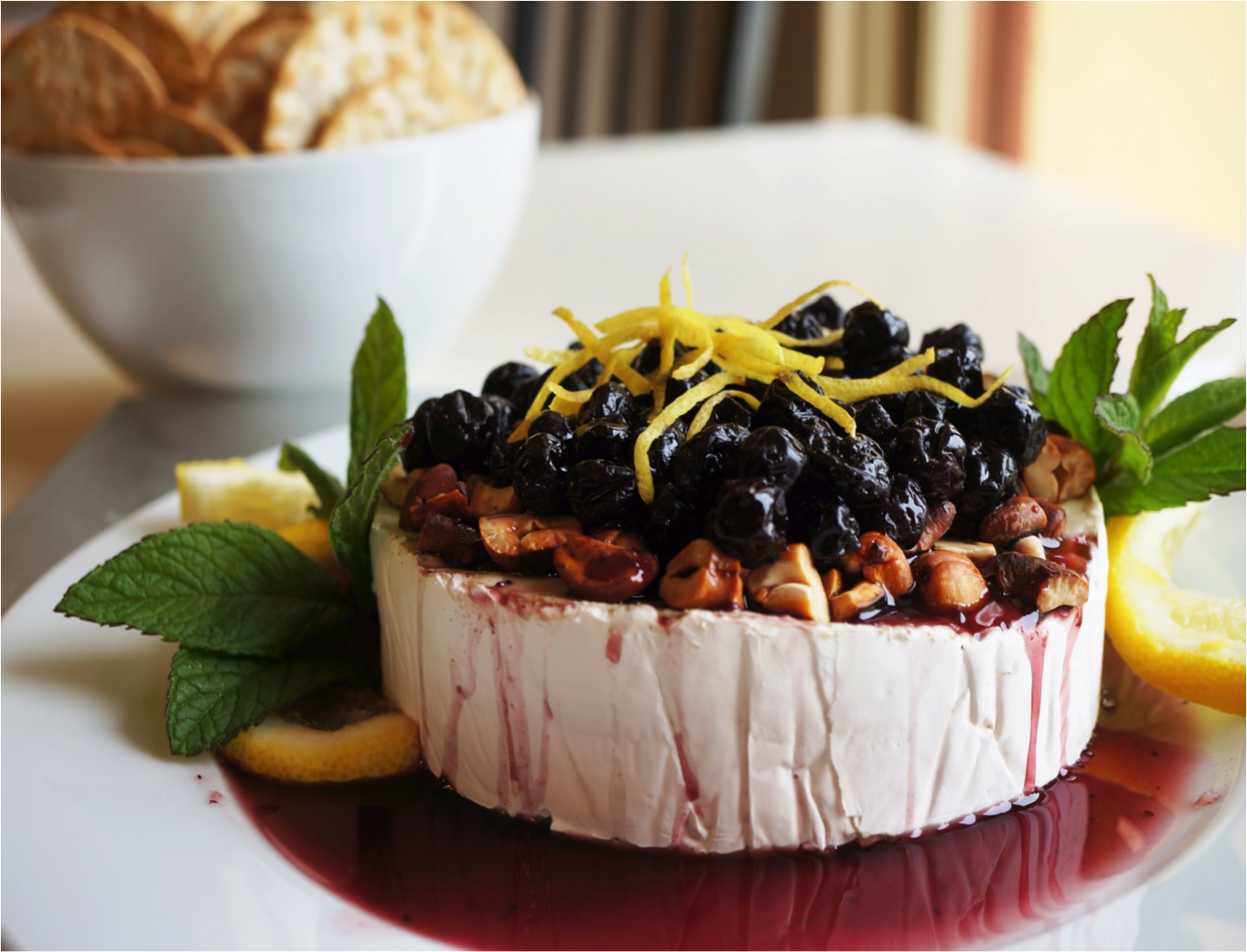 brie with lemon roasted cashews and blueberry sauce